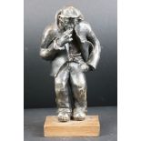 Pottery sculpture of a Welsh miner in work clothes, smoking a cigarette