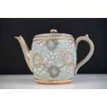 19th century Doulton Lambeth Stoneware Teapot with incised floral decoration on a pale blue