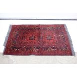 Eastern Red Ground Wool and Silk Blend Rug with geometric design, 150cm x 100cm