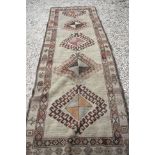 West Persian Wool Cream Ground Runner Rug with geometric design, 310cm x 102cm