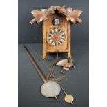 A wooden cased wall hanging cuckoo clock