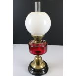 Victorian Brass Oil Lamp with Cranberry Glass Well, Opaque Bulbous Shade and Black Glazed Base, 58cm