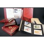 A collection of mixed stamps, first day covers and Royal Mail stamp postcards contained within