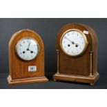 Two early 20th century wooden cased mantle clocks with white enamel dials and chiming movements.