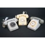 A collection of three mid 20th century dial up telephone.