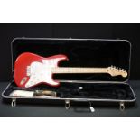 Guitar - A 1980's Fender Stratocaster made in the USA, red finish. With Fender hardcase and strap.