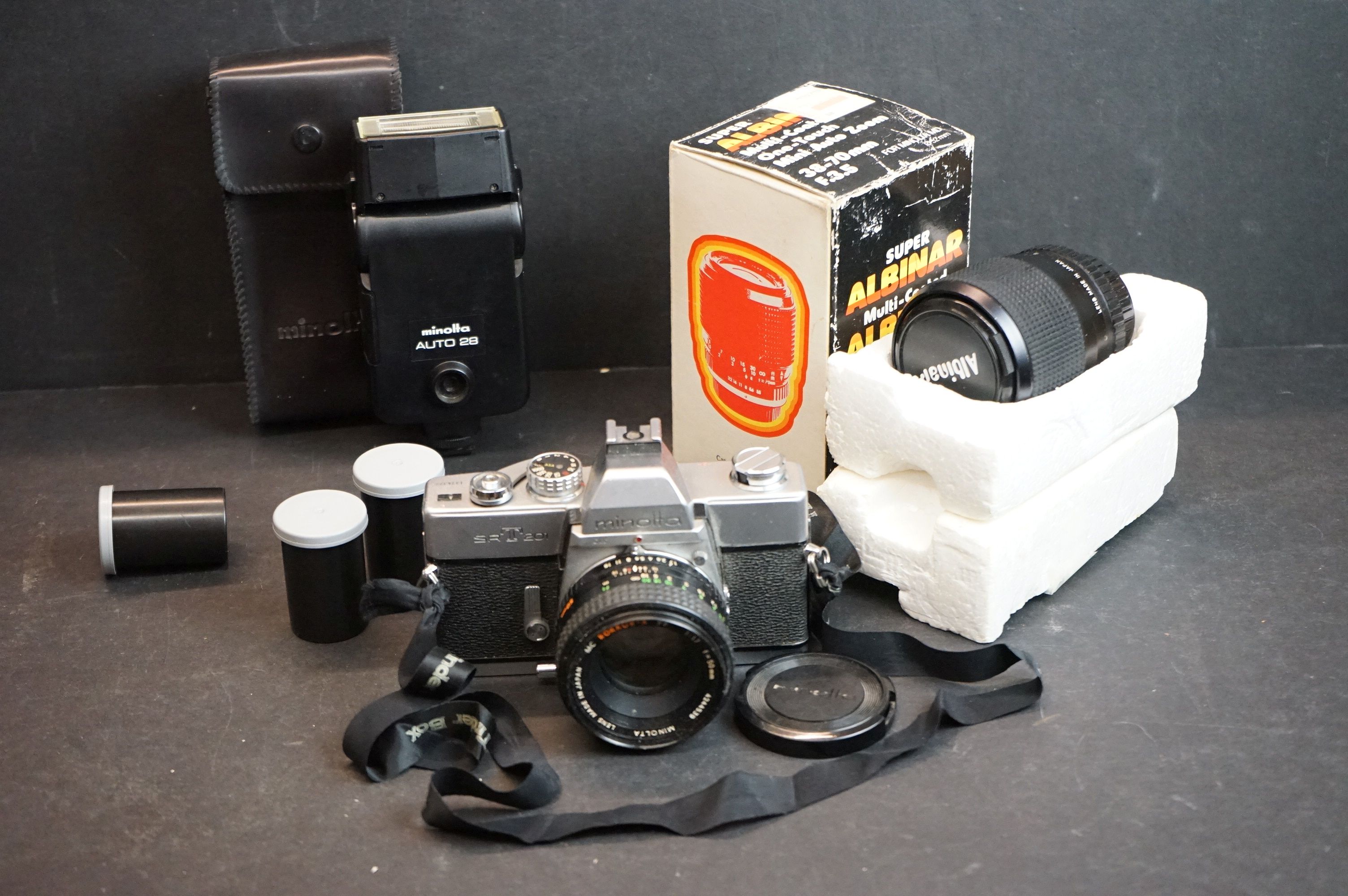 A small group of photographic equipment to include a Minolta SRT201 35mm SLR Camera.