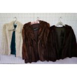 A collection of two ladies fur coats together with a white fur shawl.