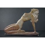 Art Deco Brass Flat Figure of a Kneeling Dancing Girl held on an ebonised wooden base, 39cm long x