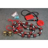 A collection of oriental amulets together with skull key chains.