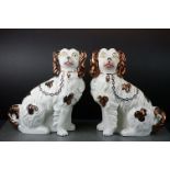 Pair of Staffordshire Mantle Spaniels with divided front legs, chains and copper lustre