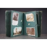 An antique Edwardian postcard album with contents to include printed and real photo postcards.