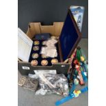 A box of mixed collectables to include commemorative coins and a collection of mixed watches.