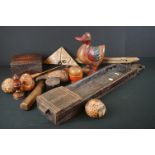 A box of mixed wooden collectables to include tribal carved ornaments and a wool shuttle.