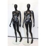 Two Full Size Standing Female Shop Mannequins with a black gloss finish held on circular glass