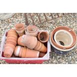 A collection of terracotta plant pots together with three larger pots.