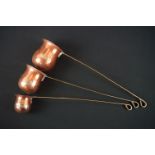 Set of three copper graduating spirit ladles