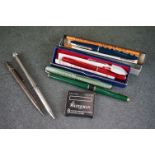 A small collection of antique and vintage pens to include a silver example.