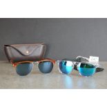 Two pairs of designer sunglasses to include Oakley and Persol examples.