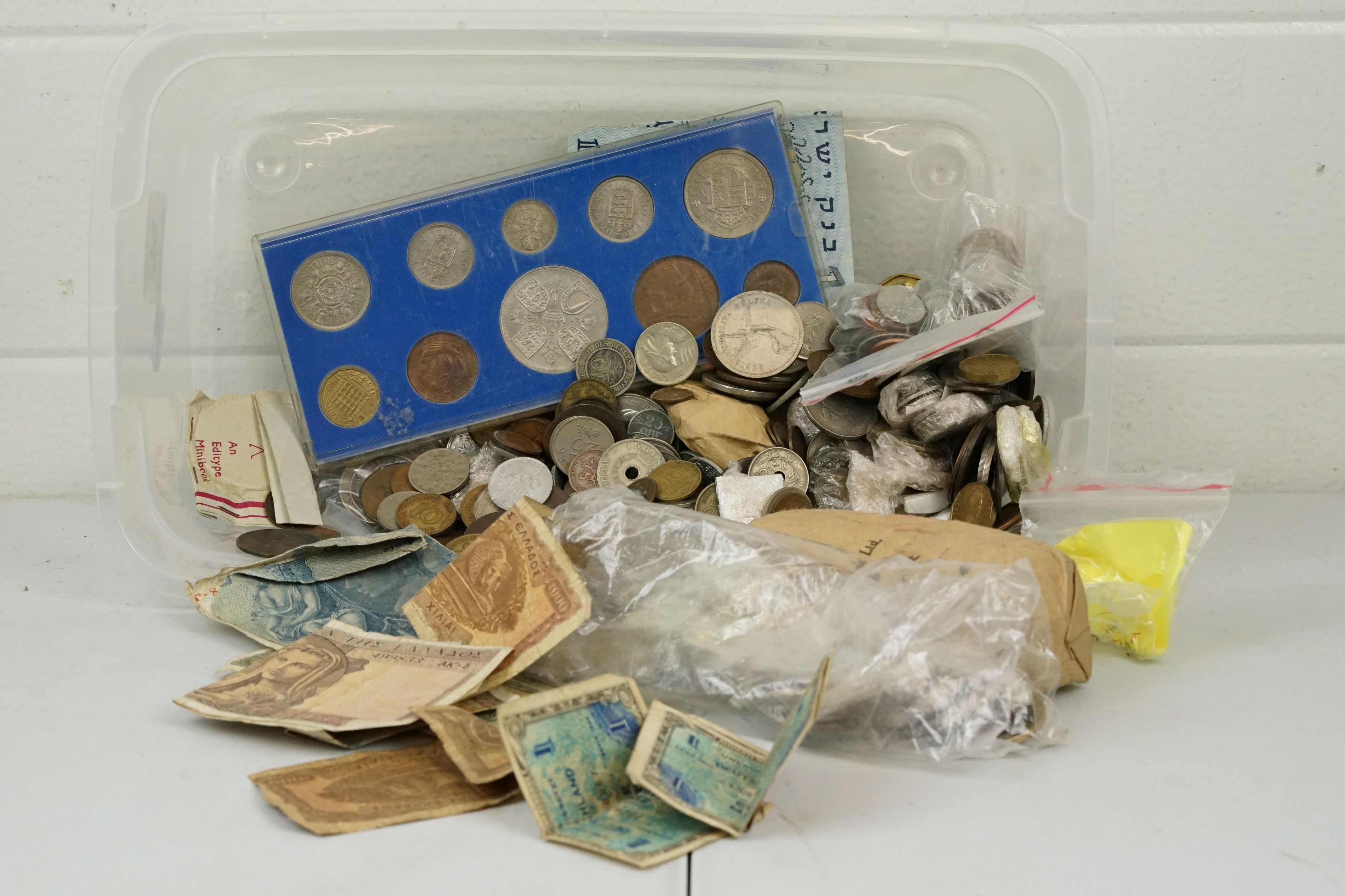 A small collection of mixed coins and banknotes to include British and foreign examples.