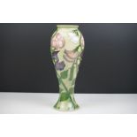 Moorcroft Green Ground Baluster Vase decorated in the Sweet Pea pattern, green impressed marks to