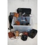 A large collection of mixed photographic equipment to include Cameras, lenses, flash guns...etc.