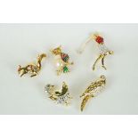 Five Costume Jewellery Brooches including part enamelled Lady Golfer, part enamelled Owl,