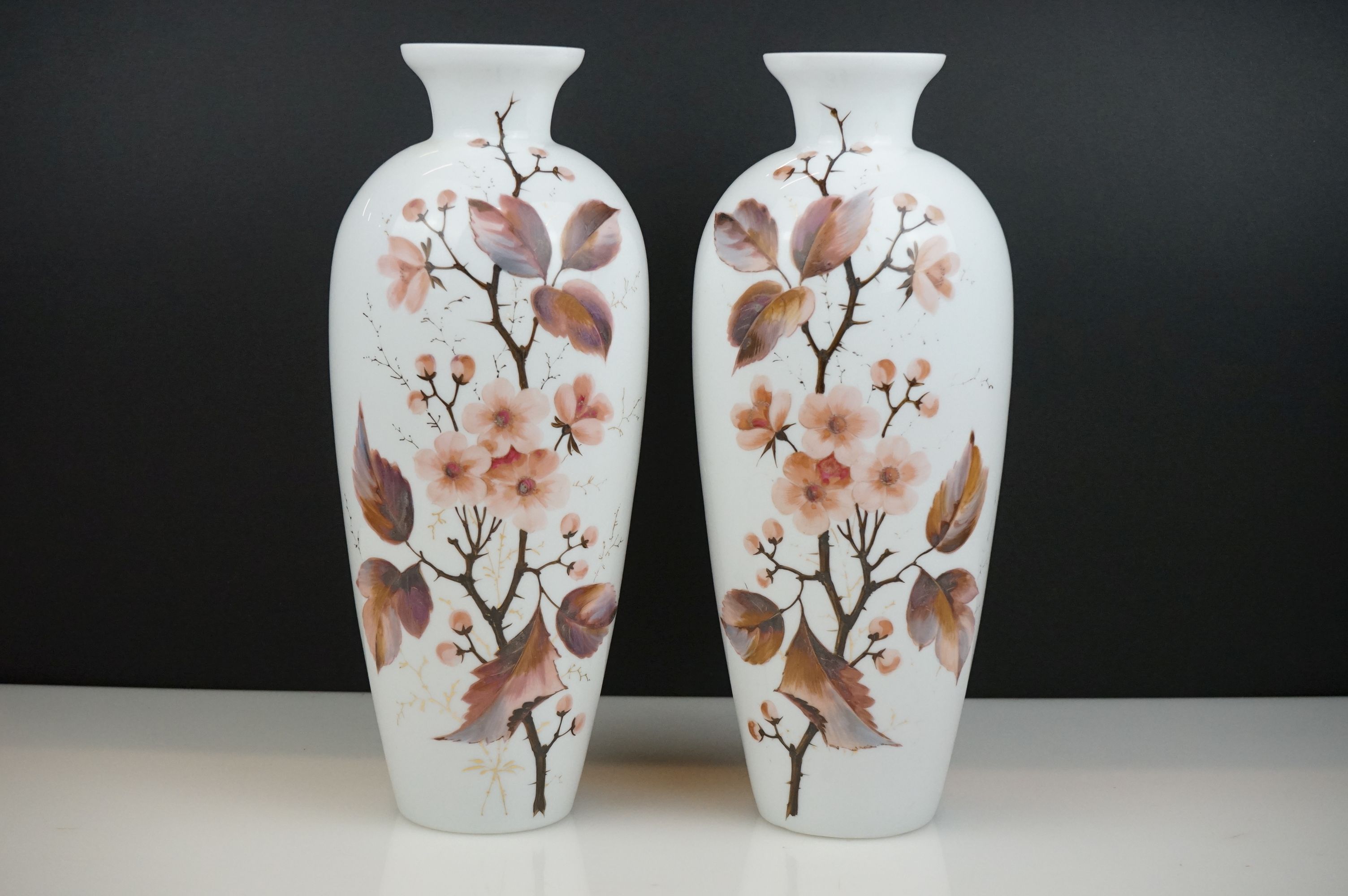 Pair of antique opaline glass vases with hand painted leaf decoration, 32cm tall