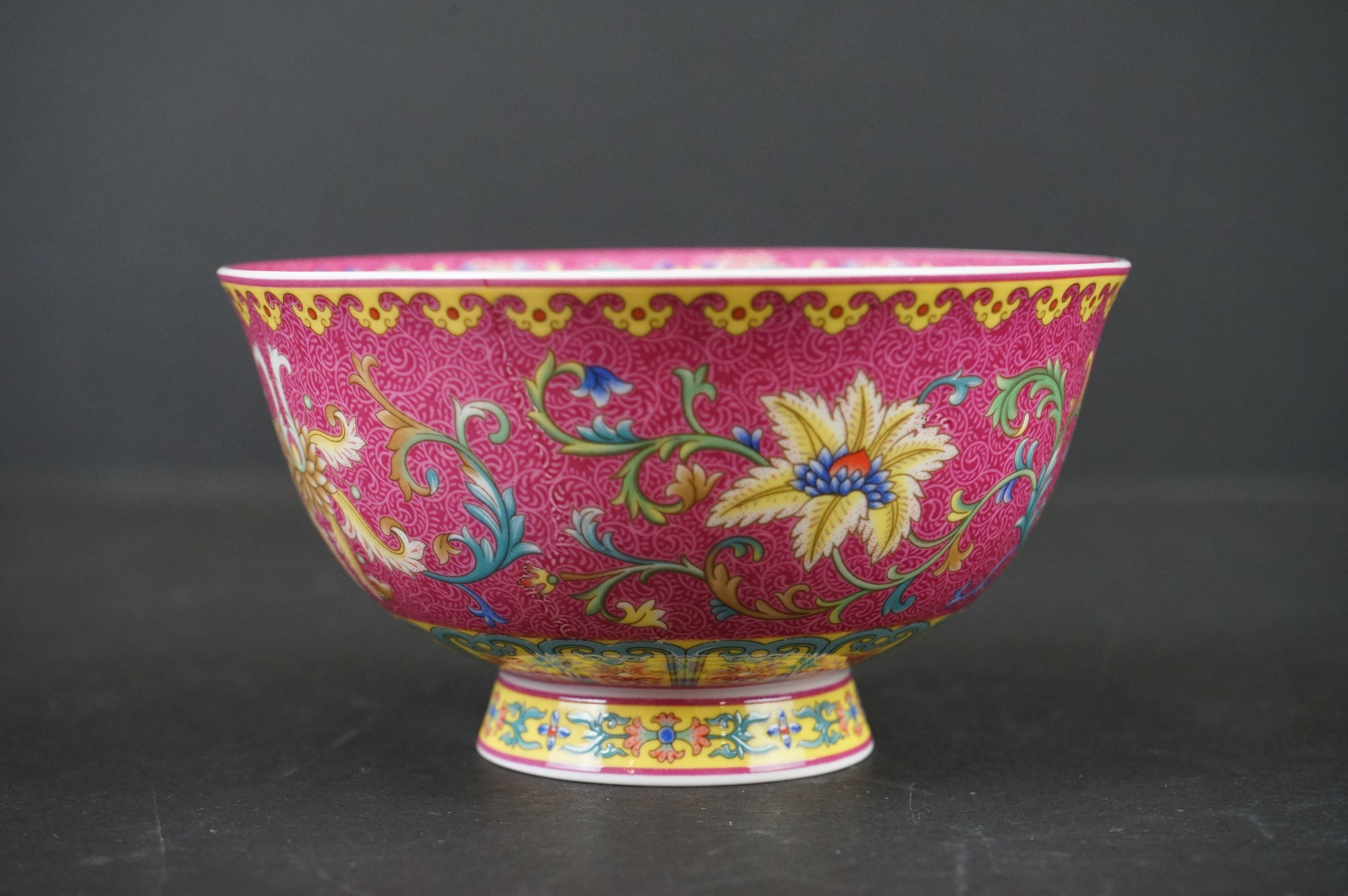 Chinese Porcelain Bowl decorated in enamels with scrolling flowers on a pink and yellow ground,