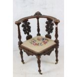 19th century style Corner Chair, the top rail heavily carved including a cherub face mask above