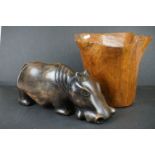Large wooden planter of organic form and a large carve hippopotamus