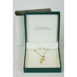 A hallmarked 9ct gold cross pendant and necklace set in gift box.