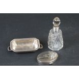 Silver topped perfume bottle along with a compact and butter dish