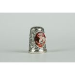 Silver thimble with enamel panel depicting a lady sewing