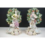 Pair of Chelsea Porcelain Bocage Figures in the form of a Man playing bagpipes with a dog and a