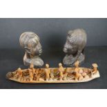 Two carved African tribal heads together with a wooden carved ornamental boat.