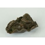 Bronze sculpture of a cherub asleep on a leaf (possibly a lily pad)