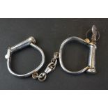 A pair of Hiatt Best screw key hand cuffs.