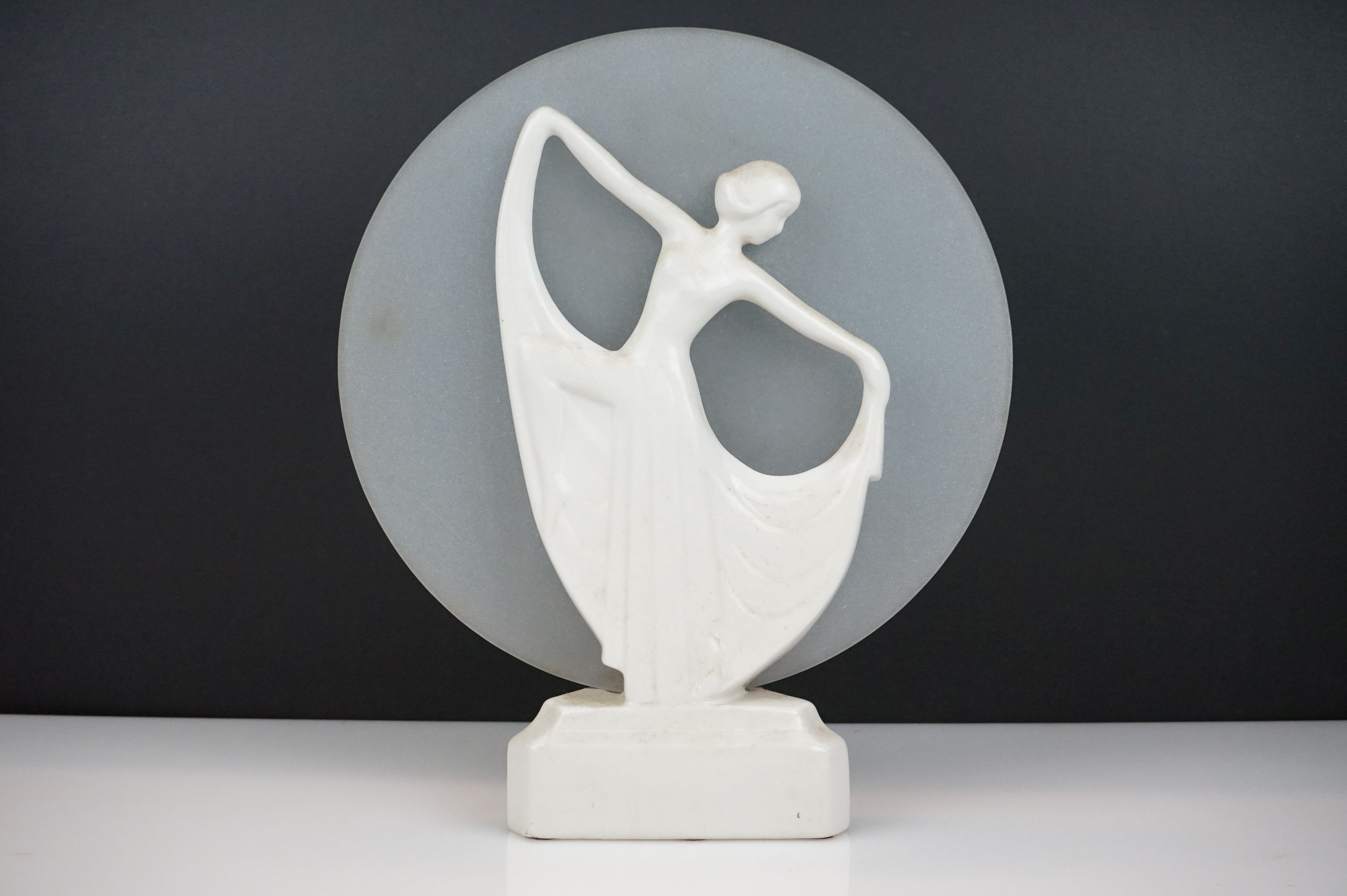 Art Deco White Ceramic Table Lamp in the form of Dancing Lady in front of a frosted glass circular