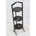 Early 20th century Black Lacquered Three Tier Folding Cake Stand with gilt decoration of Armorial