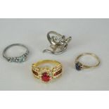 Four ladies dress rings to include one 9ct gold and three silver examples.