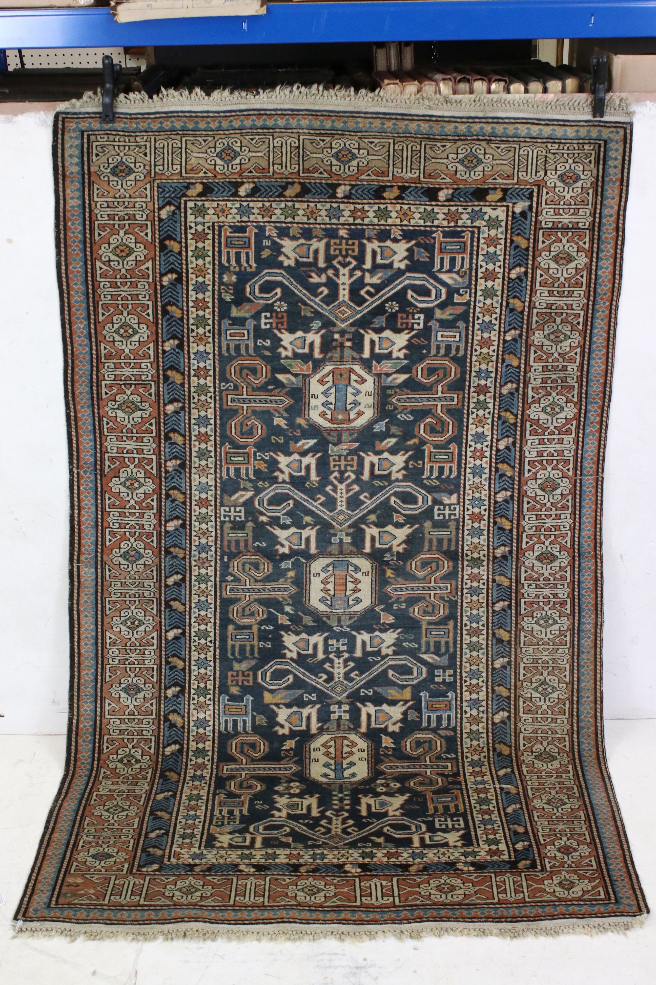 Eastern Blue Ground Wool Rug decorated with geometric patterns within a border, approx. 169cm x