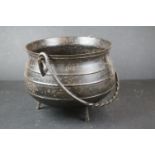Antique iron cooking pot on legs