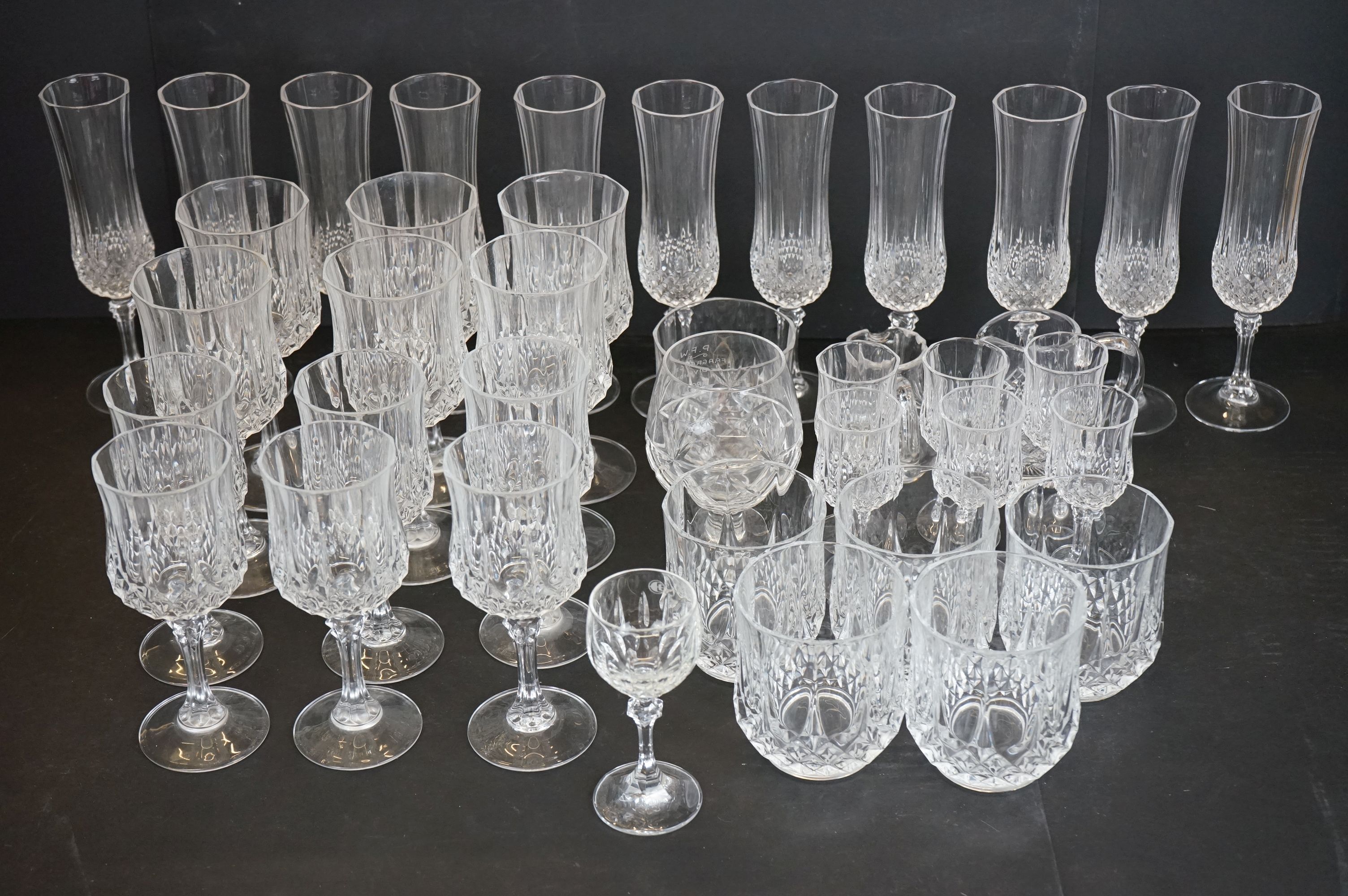 Collection of crystal cut glassware to include 11 champagne flutes, 6 red wine glasses, 6 white wine