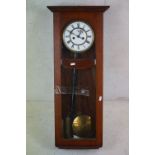 An early to mid 20th century oak cased hanging wall clock.