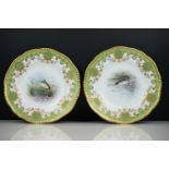 Pair of early 20th Century Coalport cabinet plates with green and gilt edged decoration, the centres