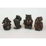 A collection of four Chinese carved wooden netsuke in the form of animals to include a Frog and an