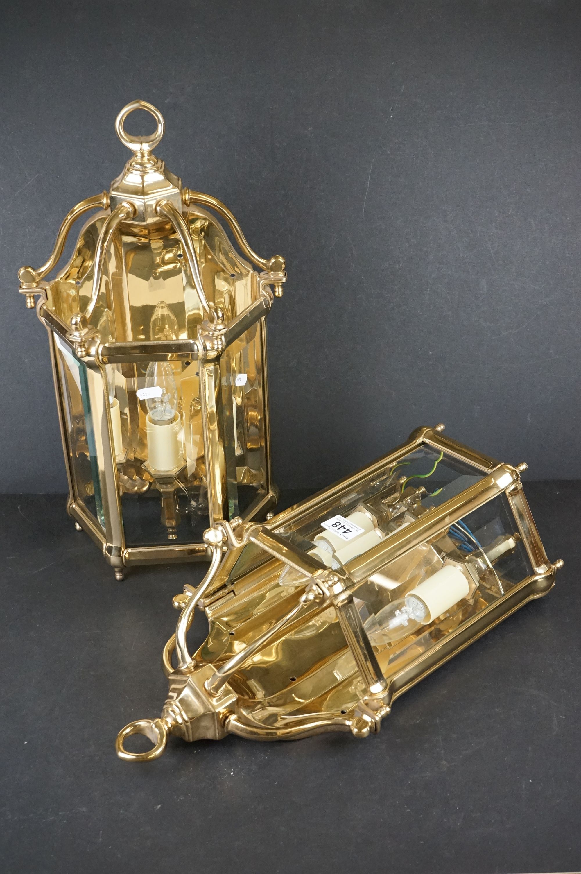 A pair of heavy gauge gilt brass wall lights in the George III style with three bevelled glass