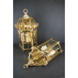 A pair of heavy gauge gilt brass wall lights in the George III style with three bevelled glass