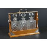 Early 20th century Oak Three Bottle Tantalus with Silver Plated Mounts marked PB & S, three matching